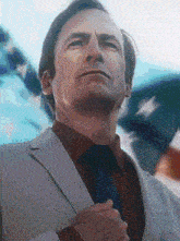 a man in a suit and tie is looking up at something