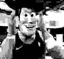 a black and white image of woody from toy story smiling .