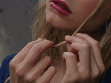 a close up of a woman 's face with red lipstick on her lips