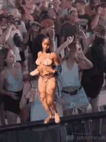 a woman in a bikini is dancing in front of a crowd of people made by unscreen
