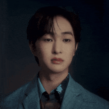 a man with his eyes closed wearing a suit