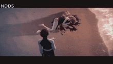 a man stands in front of a woman laying on the ground with the words nddds above her head