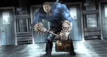 a man in a blue suit is holding a briefcase and a chain around his arms .