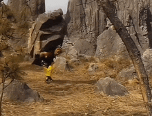 a person in a yellow jumpsuit is walking through a cave