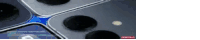a close up of a cell phone camera with a blue stripe on the bottom .