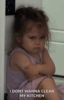 a little girl with her arms crossed and the words " i dont wanna clean my kitchen "
