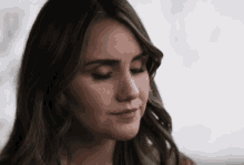 a close up of a woman 's face with closed eyes