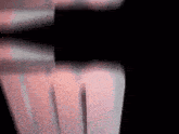 a close up of a person 's hand on a black background with a blurred background .
