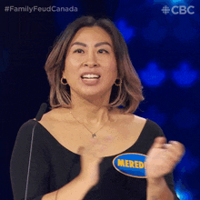 a woman with a name tag that says meredith applauds