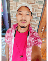 a man wearing a pink plaid shirt and a white hat is taking a selfie