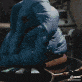 a statue of a blue elephant with a tiktok watermark on the bottom left