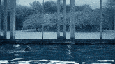 a person is swimming in a pool with a view of snowy trees outside
