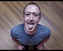 a man is sticking his tongue out at the camera .