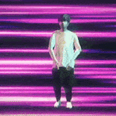 a man without a shirt is dancing in front of purple lights .