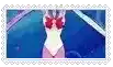 a woman in a white swimsuit with a red bow on her head is standing in a pool .