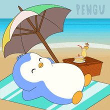 a penguin laying under an umbrella on the beach