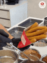 churros are being made in a kitchen with a chobrez logo in the background