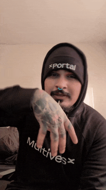 a man wearing a hoodie and a beanie with portal written on it