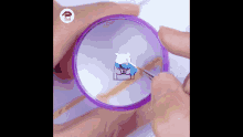 a person is holding a magnifying glass with a drawing of a dog on it