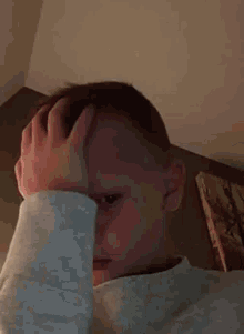 a person covering their face with their hand