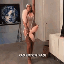 a woman in a dress is holding a stuffed animal in her hand and says yas bitch yas .