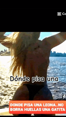 a woman in a bikini is standing in front of a body of water and the caption says donde pisa una