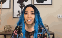 a woman with blue hair is wearing a shirt that says " i am "