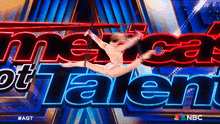 a woman is doing a split on a pole in front of the american got talent logo