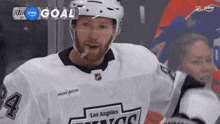 a hockey player wearing a los angeles kings jersey celebrates a goal