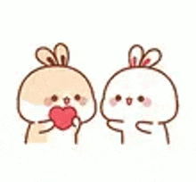 two rabbits are kissing each other with a heart in their mouths .