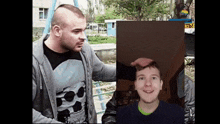 two men are standing next to each other and one has a skull on his shirt