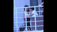 a man and a woman are sitting on a balcony