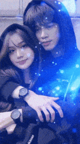 a girl wearing a watch is hugging a boy in a hoodie that says you piece