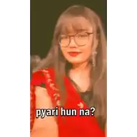 a girl wearing glasses and a red saree is asking a question .