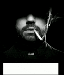a man with a mustache is smoking a cigarette in a dark room