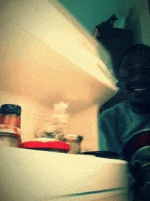 a blurred image of a person standing in a refrigerator