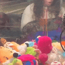 a blurred image of a woman playing a game with stuffed animals including a pink stuffed animal
