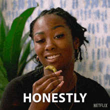 a woman is smiling and holding a piece of food in front of a netflix sign
