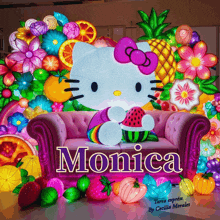 a pink couch with a hello kitty on it and the name monica