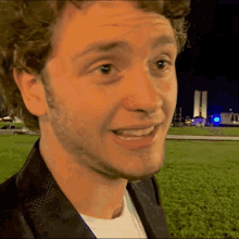 a close up of a man 's face with a building in the background