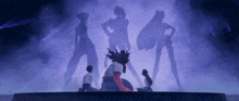 a group of people standing on a stage with their shadows on the wall behind them