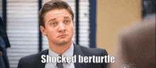 a man in a suit and tie is saying shocked bertturtle