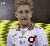 a man wearing a white shirt that says helmia on the front