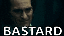 a close up of a man 's face with the word bastard written above him .