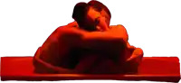 a man and woman hugging in a red room