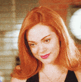 a woman with red hair is wearing a necklace and a black top