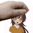 a hand is holding a cartoon character 's head .