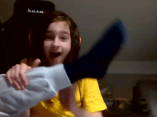 a girl wearing headphones and a huza hat holds a pillow in her hands