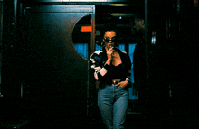 a woman smoking a cigarette in front of a door