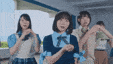 a group of girls in school uniforms are dancing
